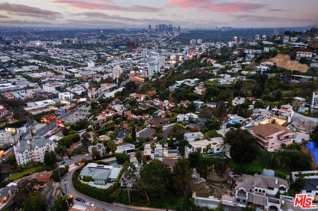 a view of a backyard with wooden fence