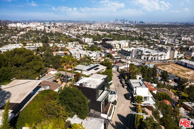 a bedroom with a bed and a view of balcony