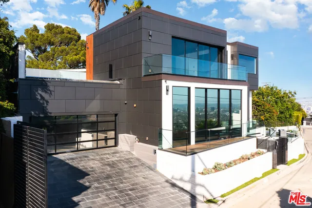 a view of a house with sitting area and garden