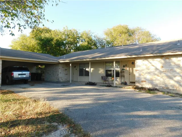 a view of a car park in front of a house