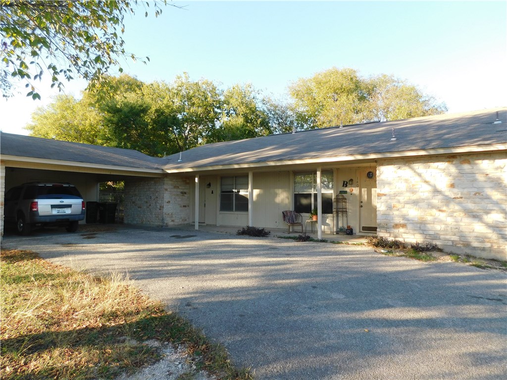 a view of a car park in front of a house