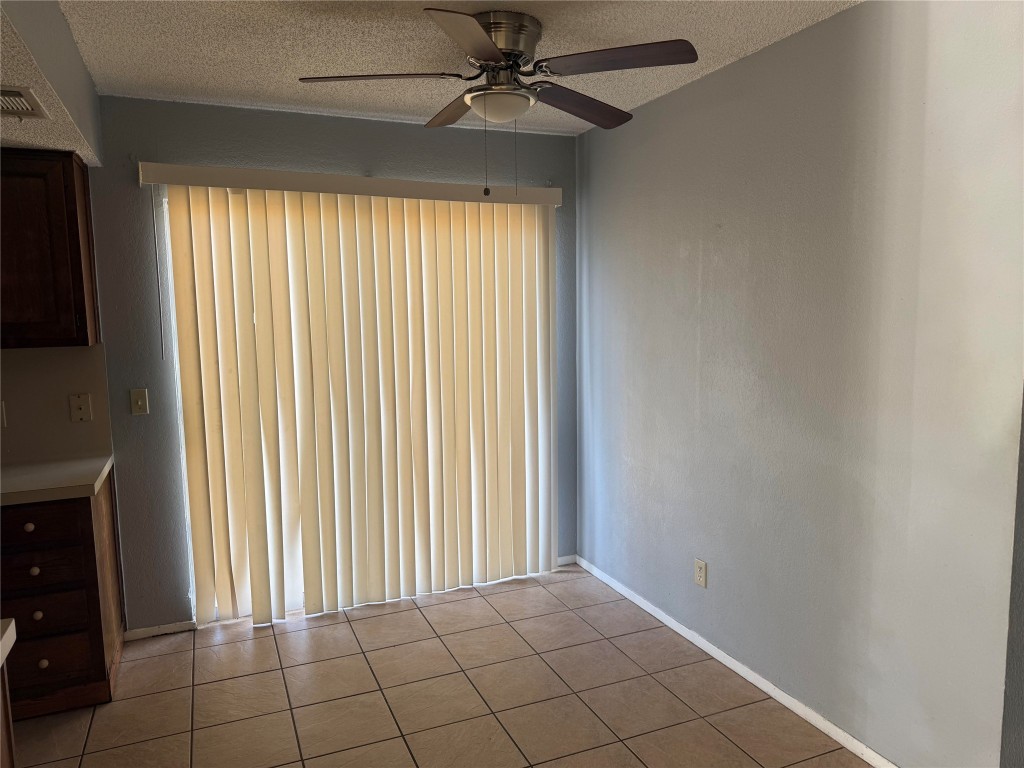 1402 Barbergale Street, Unit A Pflugerville, TX 78660 - Photo 14 of 15 an empty room with windows and fan
