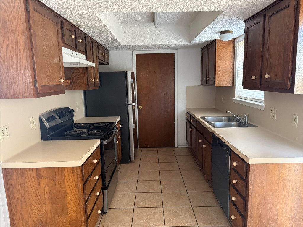 1402 Barbergale Street, Unit A Pflugerville, TX 78660 - Photo 15 of 15 a kitchen with stainless steel appliances granite countertop a stove a refrigerator and a sink