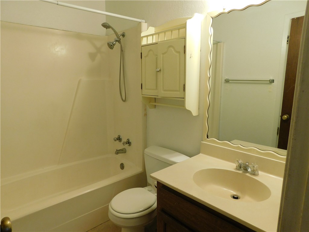 1402 Barbergale Street, Unit A Pflugerville, TX 78660 - Photo 7 of 15 a bathroom with a sink a toilet and shower