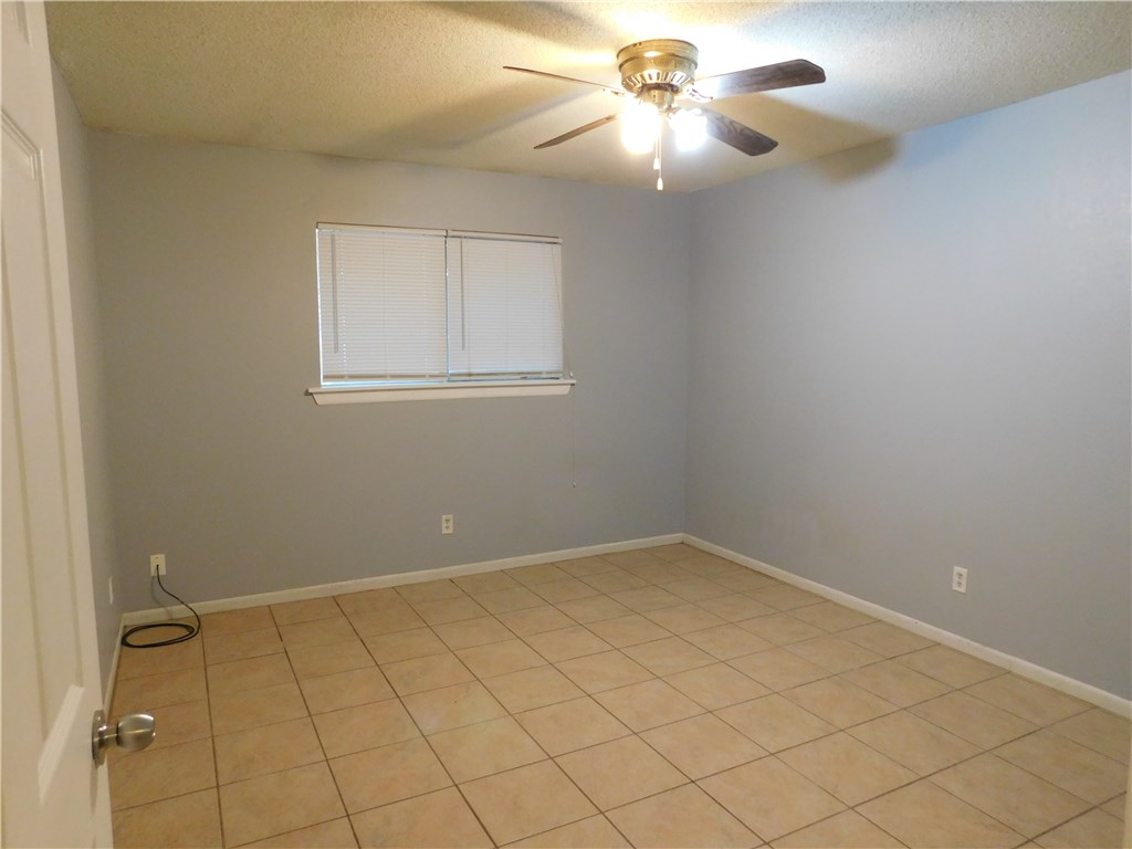 1402 Barbergale Street, Unit A Pflugerville, TX 78660 - Photo 9 of 15 an empty room with a chandelier fan