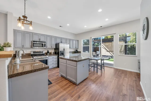 a kitchen with stainless steel appliances granite countertop a stove oven and a refrigerator