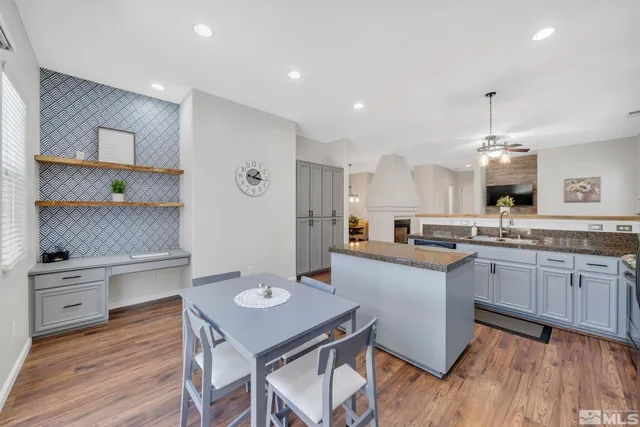 a kitchen with granite countertop a sink stainless steel appliances and cabinets
