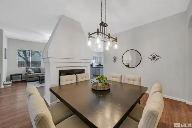 a view of a dining room with furniture wooden floor and chandelier