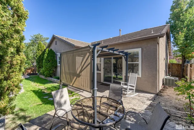 a view of swimming pool with outdoor seating and a patio