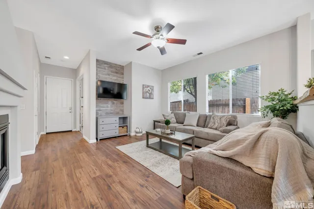 a kitchen with granite countertop a stove top oven a sink dishwasher a dining table and chairs with wooden floor