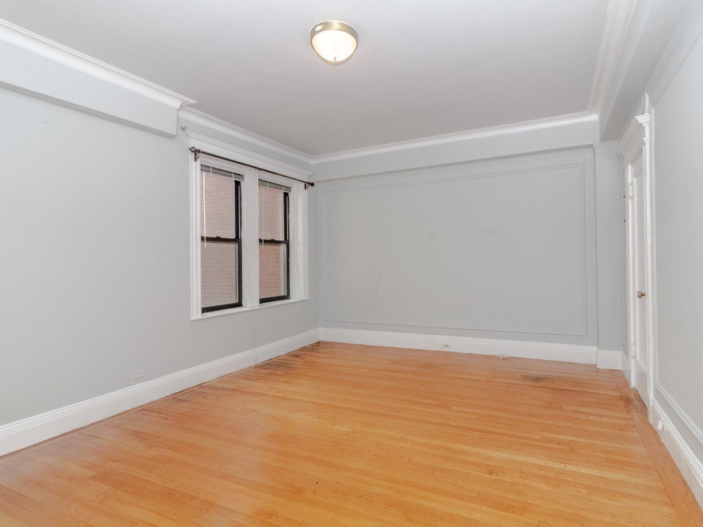 466 Commonwealth Avenue, Unit 503 Boston, MA 02215 - Photo 11 of 17 wooden floor in an empty room