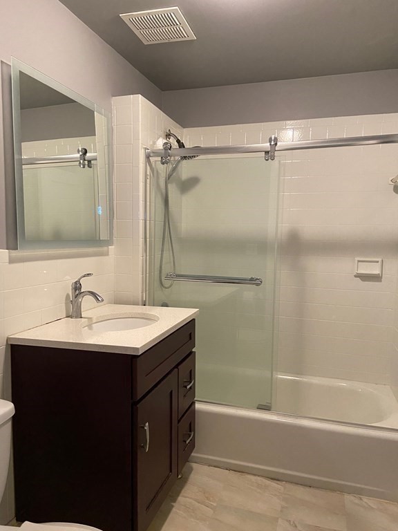 466 Commonwealth Avenue, Unit 503 Boston, MA 02215 - Photo 13 of 17 a bathroom with a sink mirror toilet and bathtub