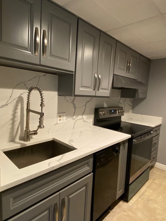 466 Commonwealth Avenue, Unit 503 Boston, MA 02215 - Photo 3 of 17 a kitchen with stainless steel appliances granite countertop a sink a stove and cabinets