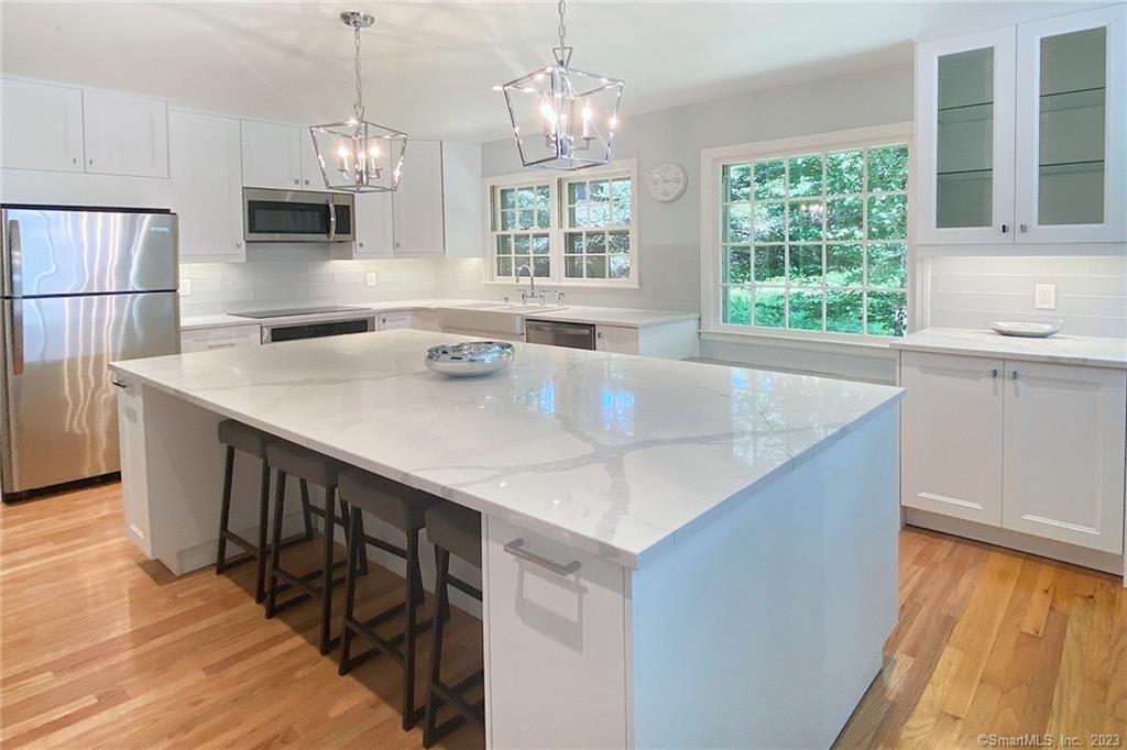 177 Brett Road Fairfield, CT 06824 - Photo 1 of 26 a kitchen with stainless steel appliances granite countertop a sink a stove and a refrigerator