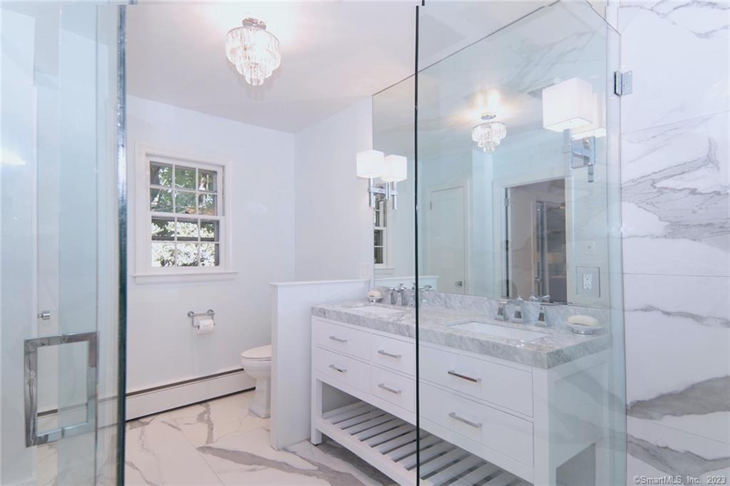 177 Brett Road Fairfield, CT 06824 - Photo 18 of 26 a bathroom with a double vanity sink a mirror and a shower