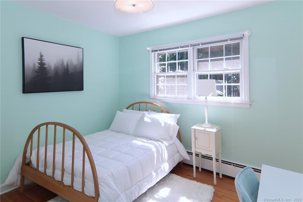 177 Brett Road Fairfield, CT 06824 - Photo 19 of 26 a bedroom with a bed and a window