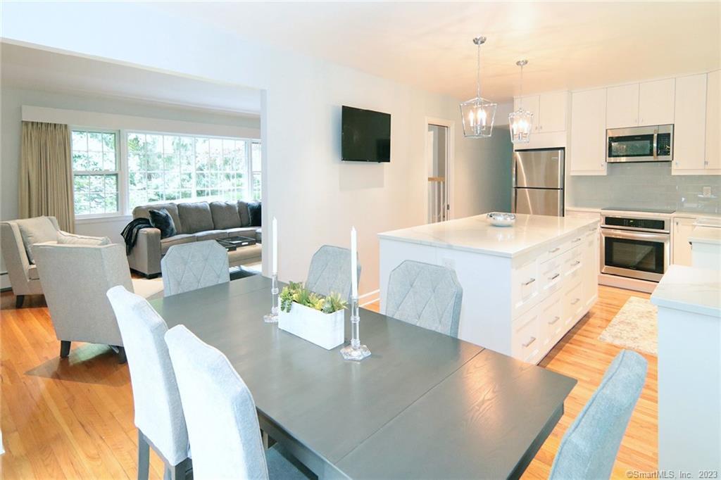 177 Brett Road Fairfield, CT 06824 - Photo 2 of 26 a living room with stainless steel appliances furniture a flat screen tv and a large window