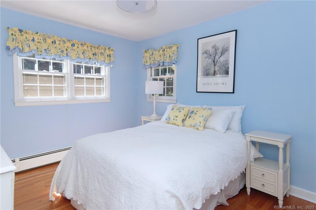 177 Brett Road Fairfield, CT 06824 - Photo 21 of 26 a bedroom with a bed and a large window