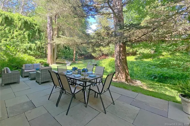 a view of a backyard with a table and chairs
