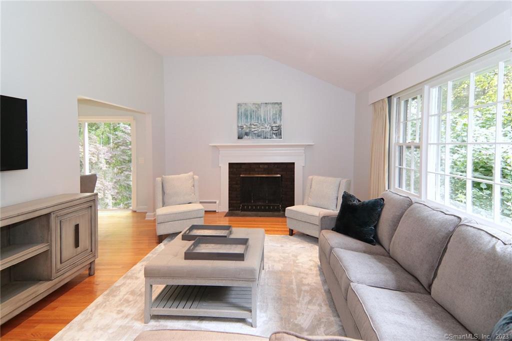 177 Brett Road Fairfield, CT 06824 - Photo 6 of 26 a living room with furniture a fireplace and a flat screen tv
