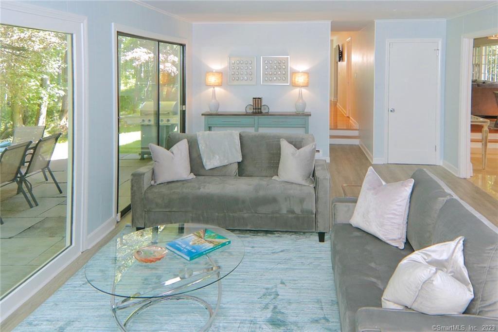 177 Brett Road Fairfield, CT 06824 - Photo 10 of 26 a living room with furniture and a floor to ceiling window