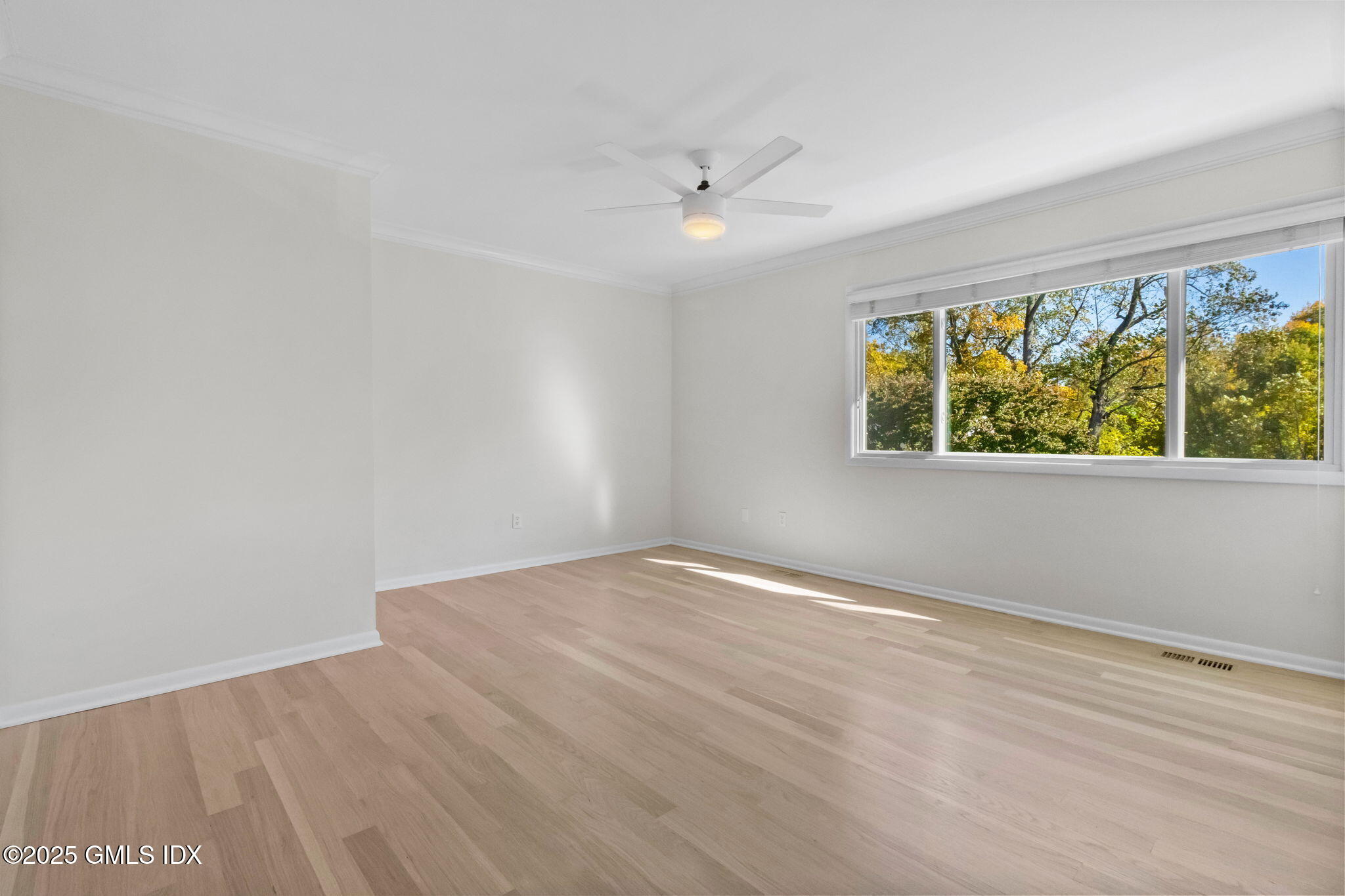 83 Silo Circle Riverside, CT 06878 - Photo 19 of 30 an empty room with wooden floor and windows