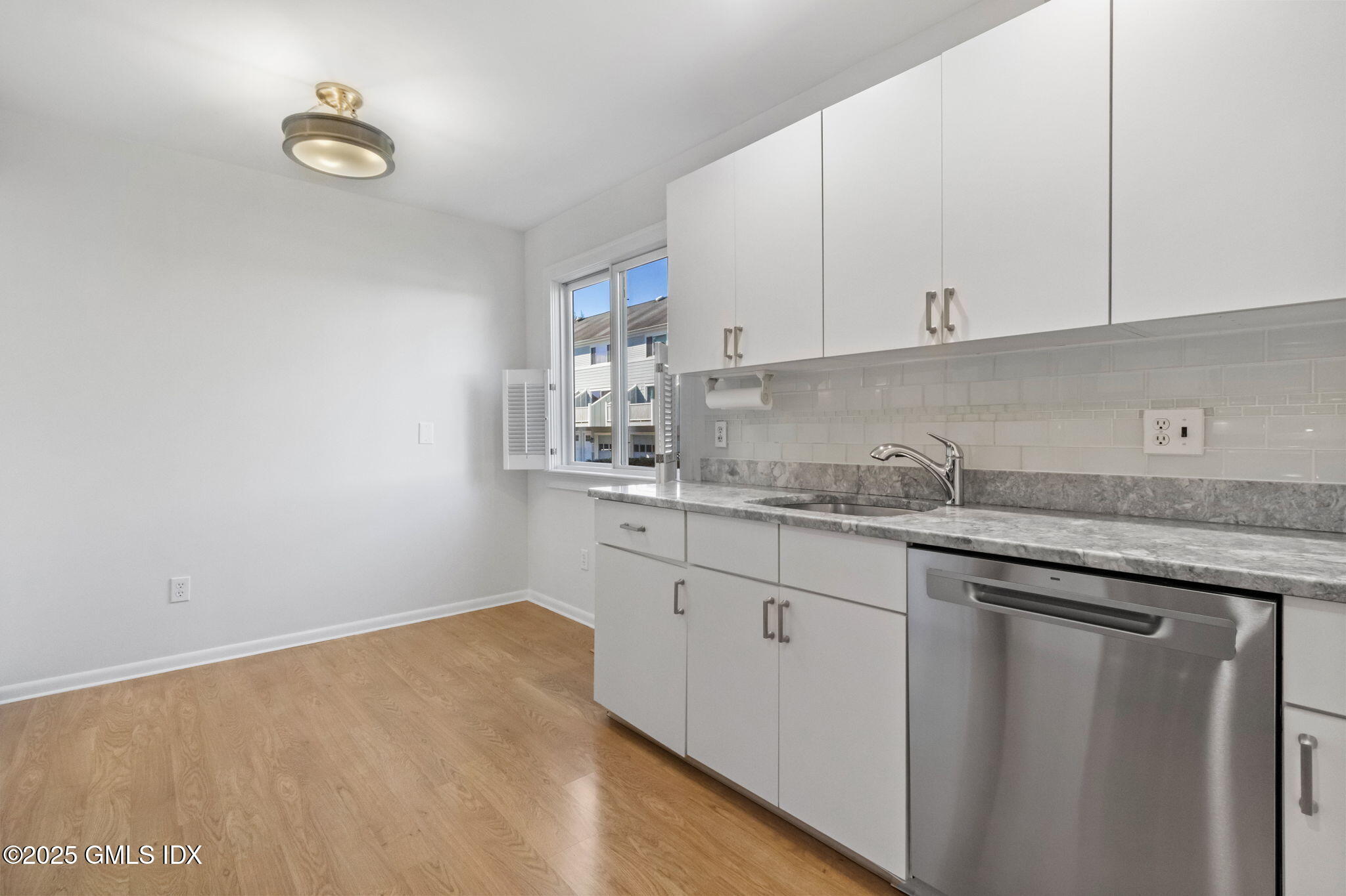 83 Silo Circle Riverside, CT 06878 - Photo 8 of 30 a kitchen with granite countertop a sink and cabinets