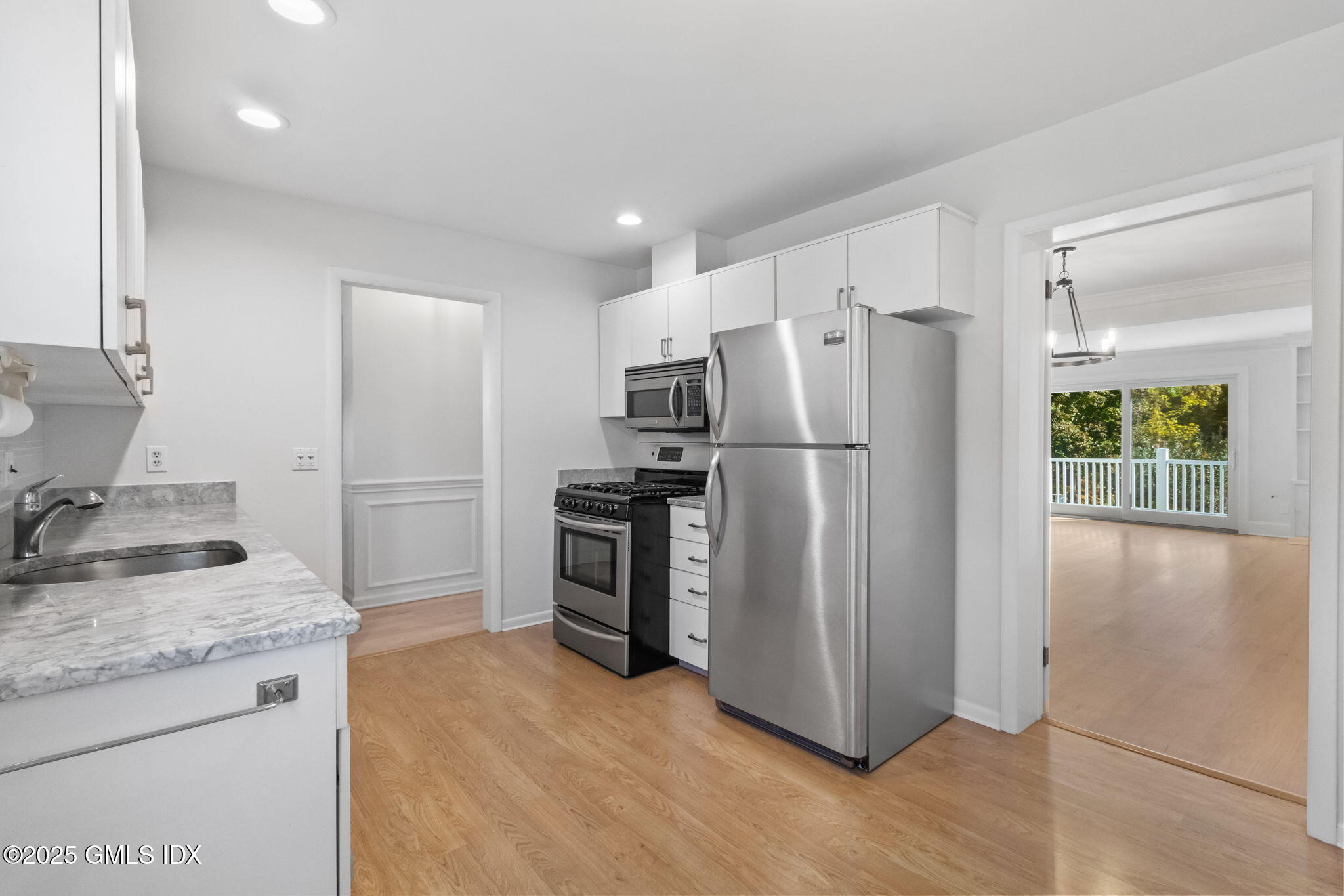 83 Silo Circle Riverside, CT 06878 - Photo 10 of 30 a kitchen with granite countertop a refrigerator and a sink