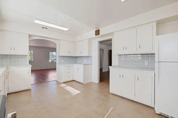 a kitchen with cabinets and a stove top oven