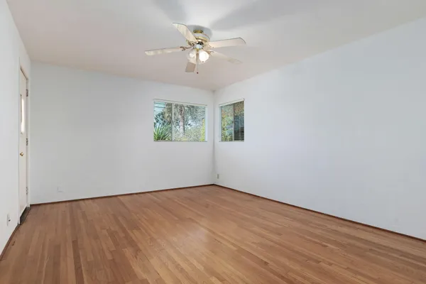 wooden floor in an empty room with a window
