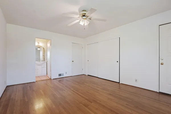 a view of an empty room with wooden floor