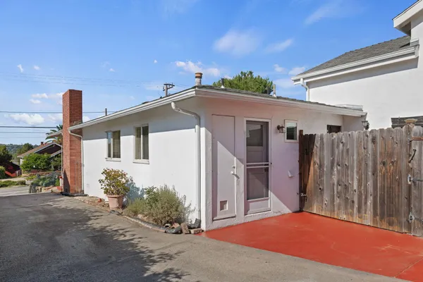 a view of a house with wooden floor and a fence