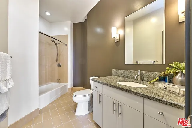 a bathroom with a toilet sink and shower