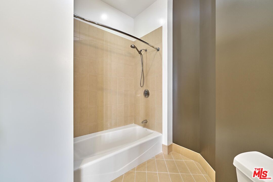 3810 Wilshire Boulevard, Unit 404 Los Angeles, CA 90010 - Photo 24 of 43 a bathroom with a bathtub and shower