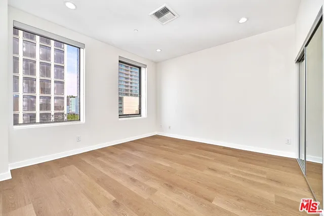 a balcony with chairs and a rug
