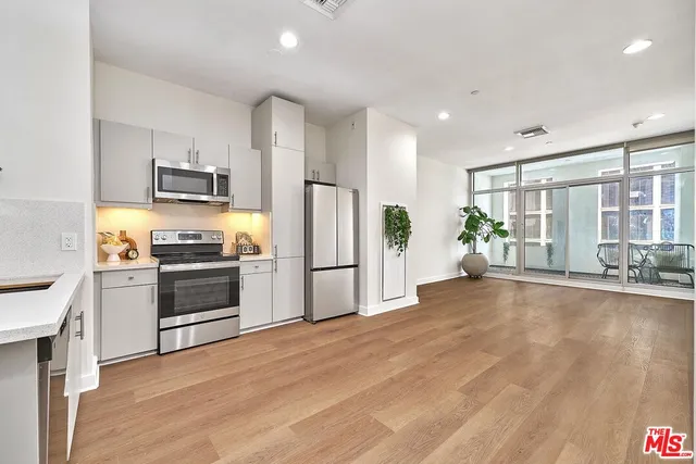 a kitchen with stainless steel appliances a refrigerator and a stove top oven