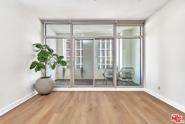 a view of empty room with wooden floor
