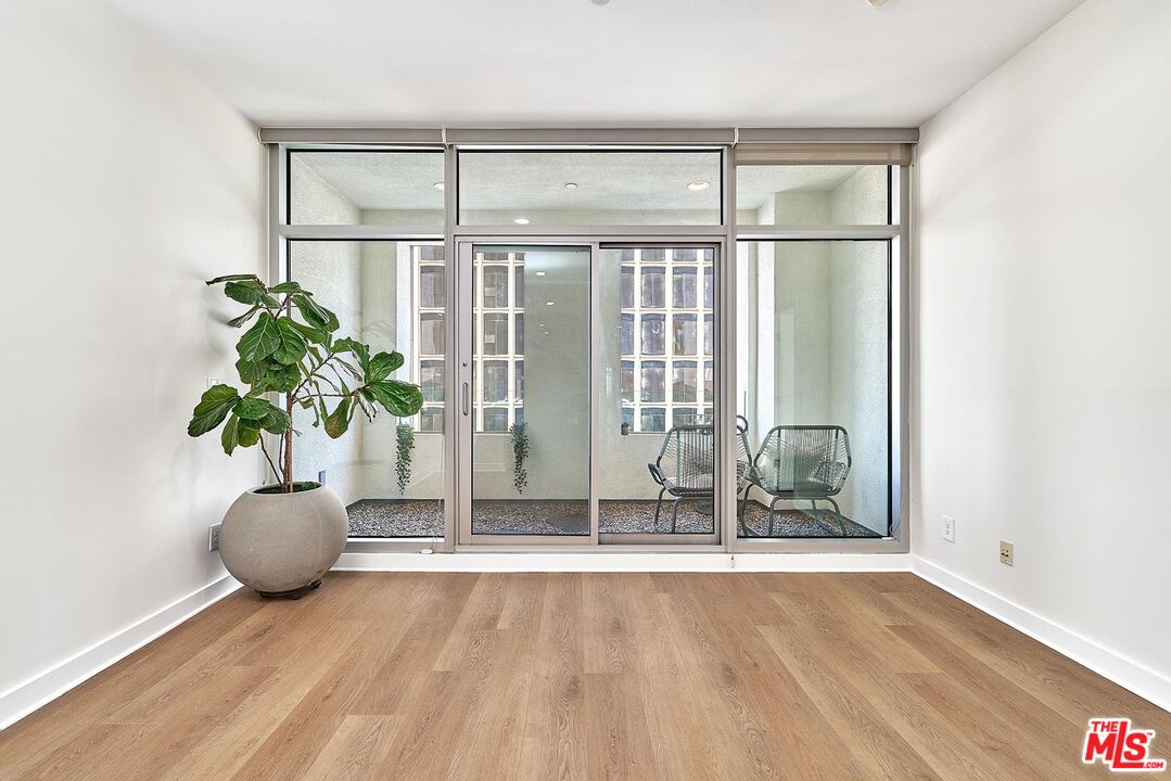 3810 Wilshire Boulevard, Unit 404 Los Angeles, CA 90010 - Photo 9 of 43 a view of a room with wooden floor and potted plant