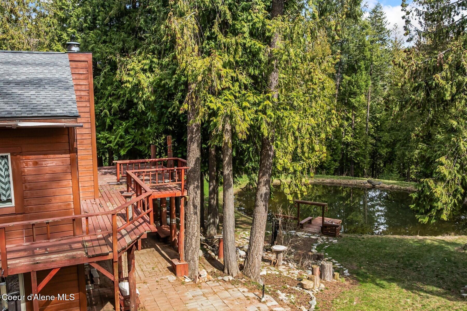 177 Hawkins Spur Road Sagle, ID 83860 - Photo 38 of 70 Wraparound Deck Overlooks Pond