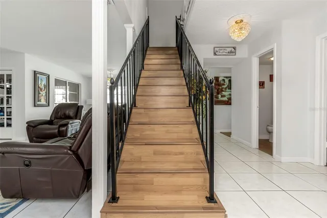 a view of a dining room with furniture a chandelier and wooden floor