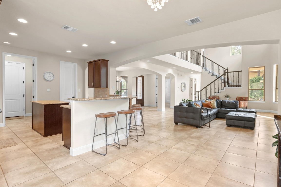 106 Tonkawa Trail West Austin, TX 78738 - Photo 15 of 39 a living room with furniture and a dining table with kitchen view