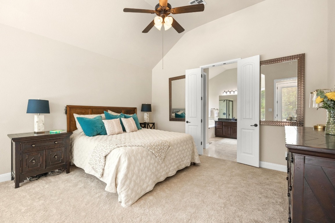 106 Tonkawa Trail West Austin, TX 78738 - Photo 16 of 39 a spacious bedroom with a bed and ceiling fan