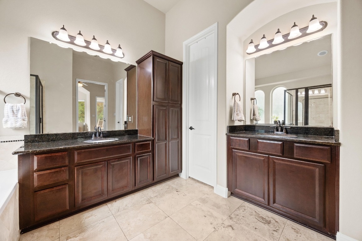 106 Tonkawa Trail West Austin, TX 78738 - Photo 19 of 39 a bathroom with a sink vanity and a mirror
