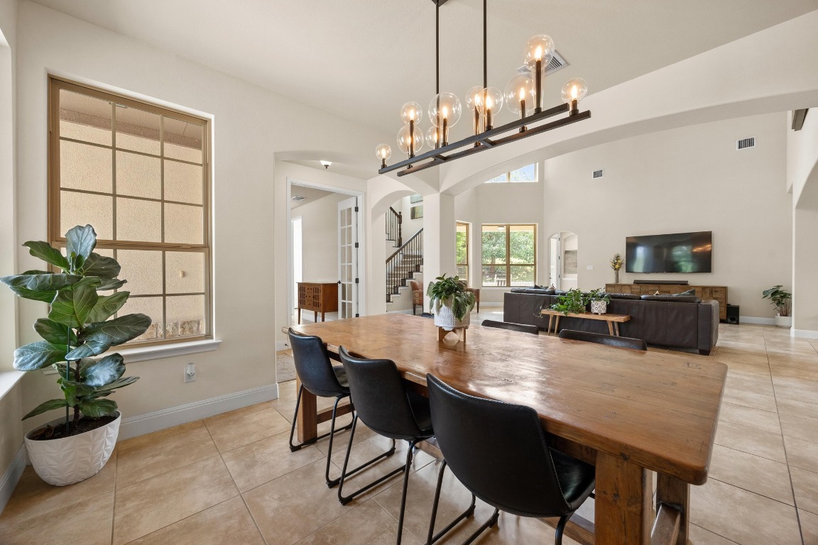106 Tonkawa Trail West Austin, TX 78738 - Photo 2 of 39 a view of a dining room with furniture and a chandelier