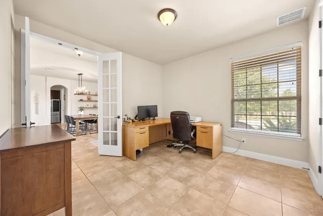 a view of a livingroom with workspace and a window