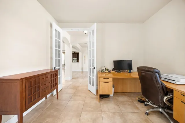 a view of a workspace with furniture and a flat screen tv