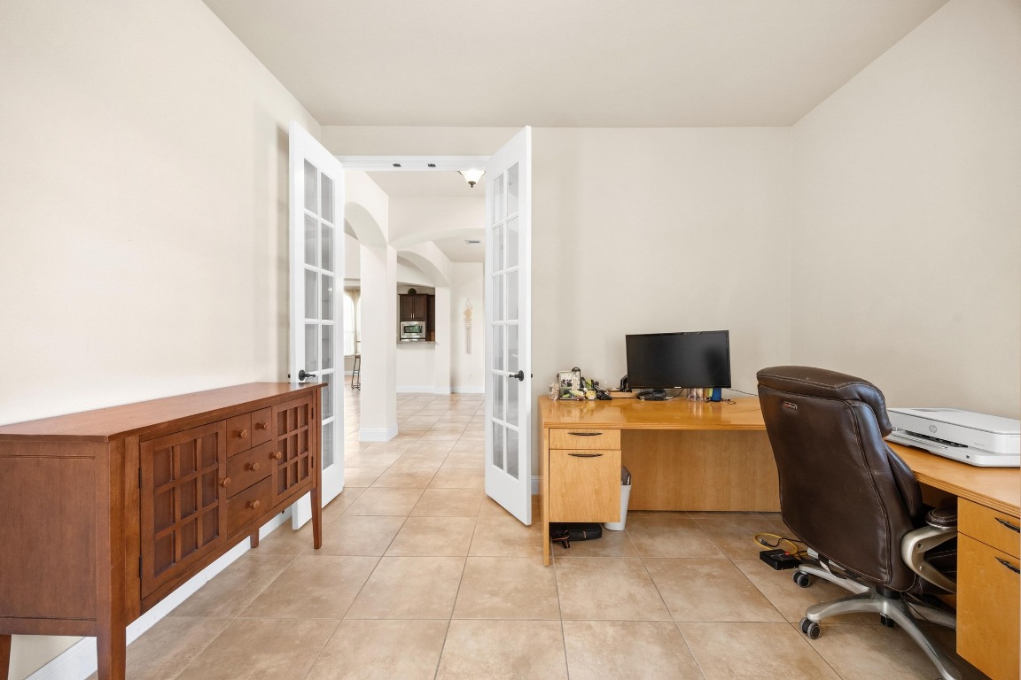 106 Tonkawa Trail West Austin, TX 78738 - Photo 22 of 39 a view of a workspace with furniture and a flat screen tv