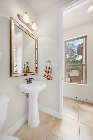 a bathroom with a sink a mirror and a vanity