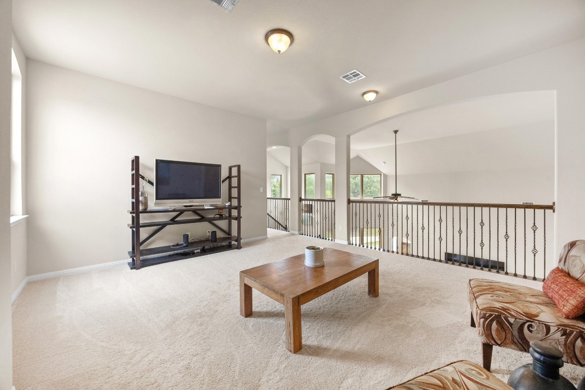 106 Tonkawa Trail West Austin, TX 78738 - Photo 25 of 39 a living room with furniture a flat screen tv and floor to ceiling window