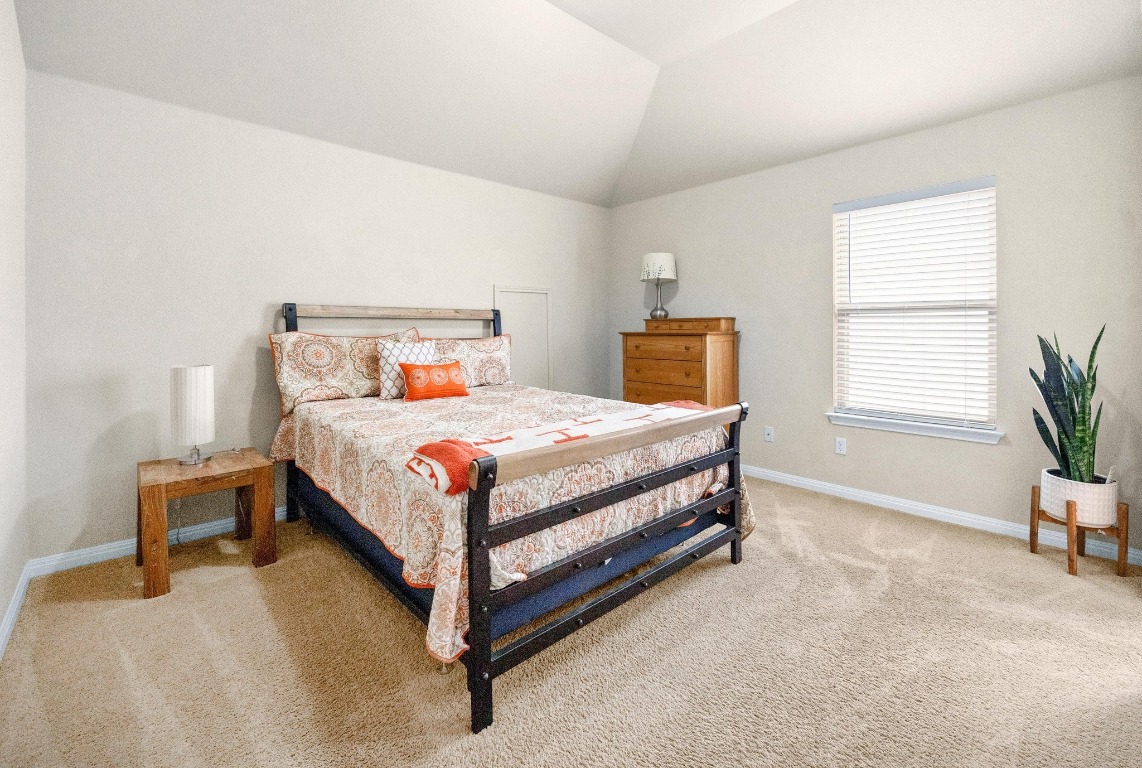 106 Tonkawa Trail West Austin, TX 78738 - Photo 27 of 39 a bed sitting in a bedroom next to a window